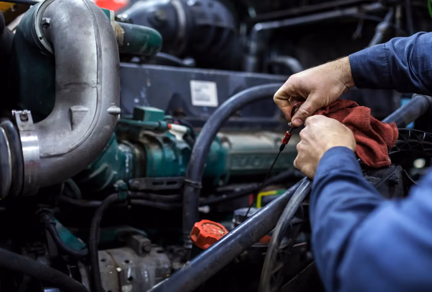 Mobile diesel mechanic performing oil & fluid service on truck fleet in Riverside, CA