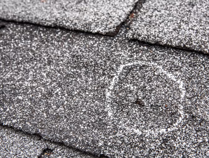 Close up of hail damage on a home's roof 