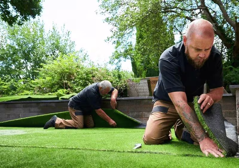 Ecoshield turf installers placing a new residential astroturf lawn
