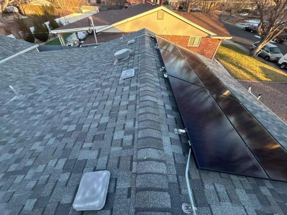 Denver roof replacement completed with solar panel integration and new shingles