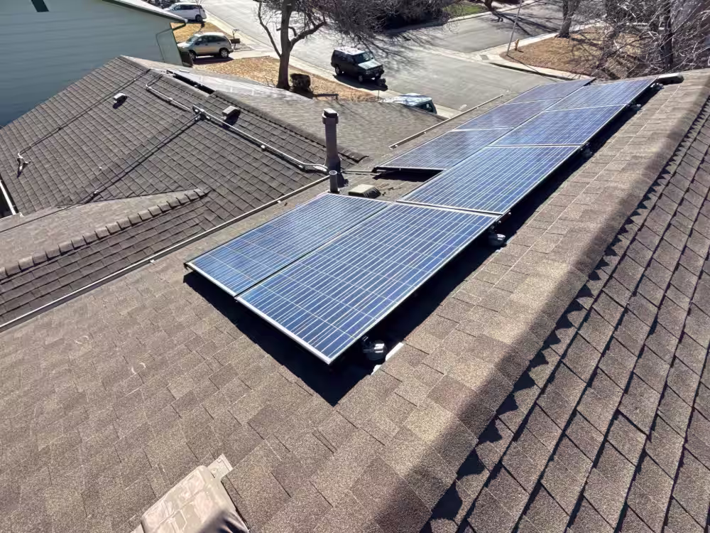 Residential roof replacement in Denver featuring solar panels and upgraded shingle system