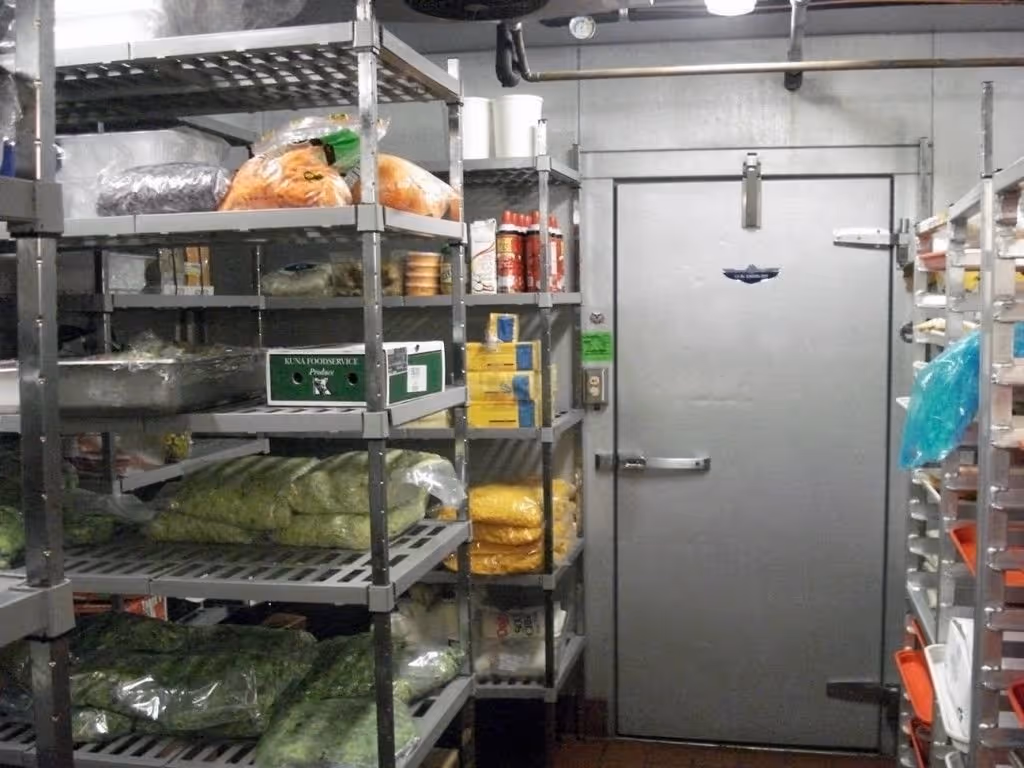 Inside a fully stocked restaurant walk-in fridge. Restaurant equipment.
