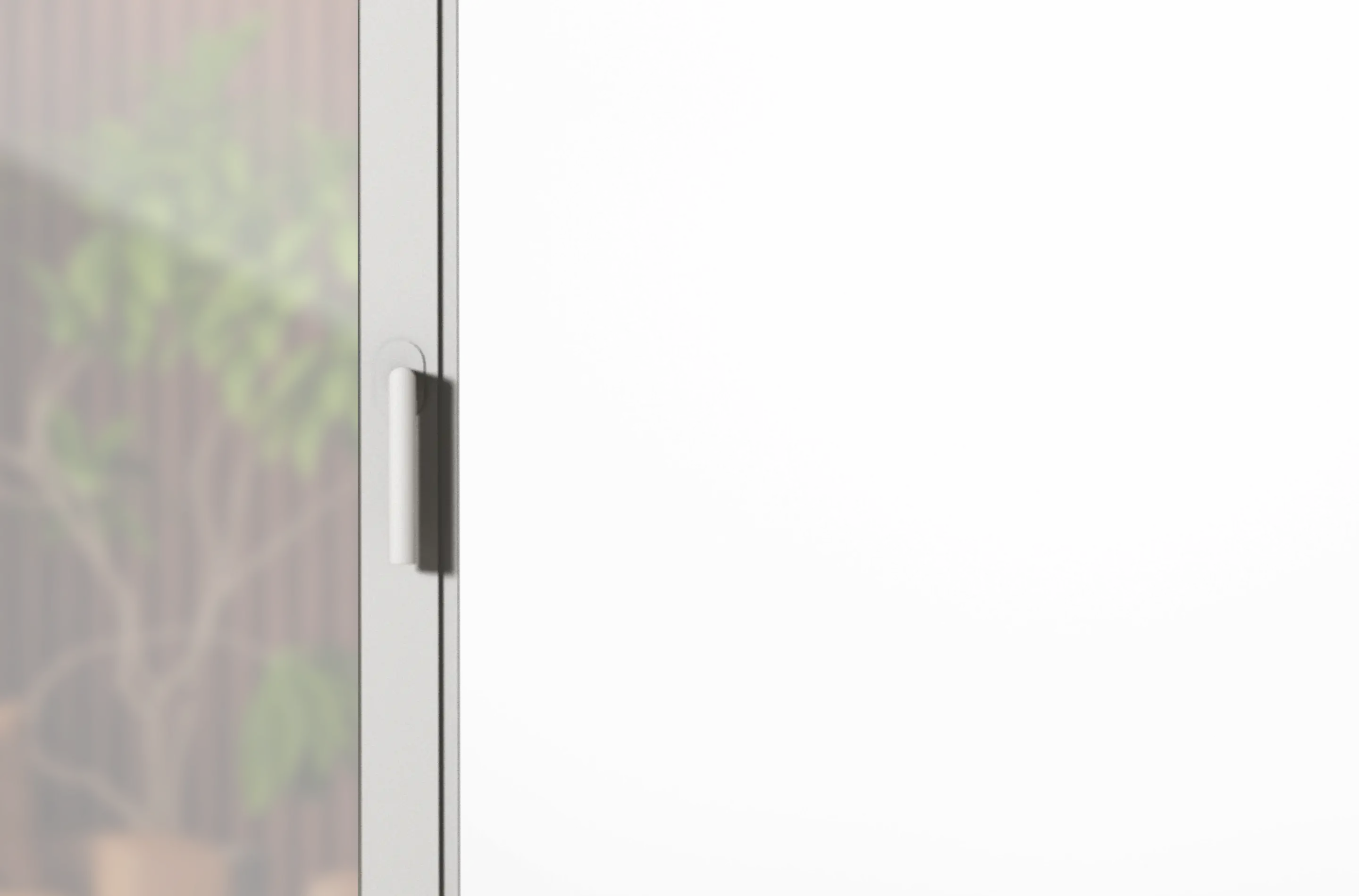 Nahaufnahme eines weißen Schranktürgriffs mit verschwommenem Hintergrund einer Pflanze.