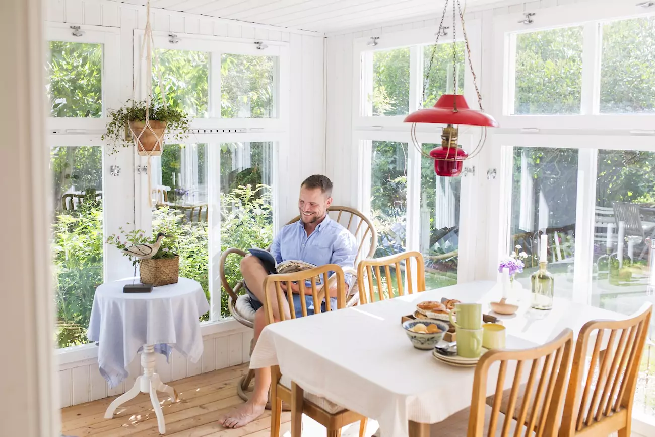 Man reading in conservatory