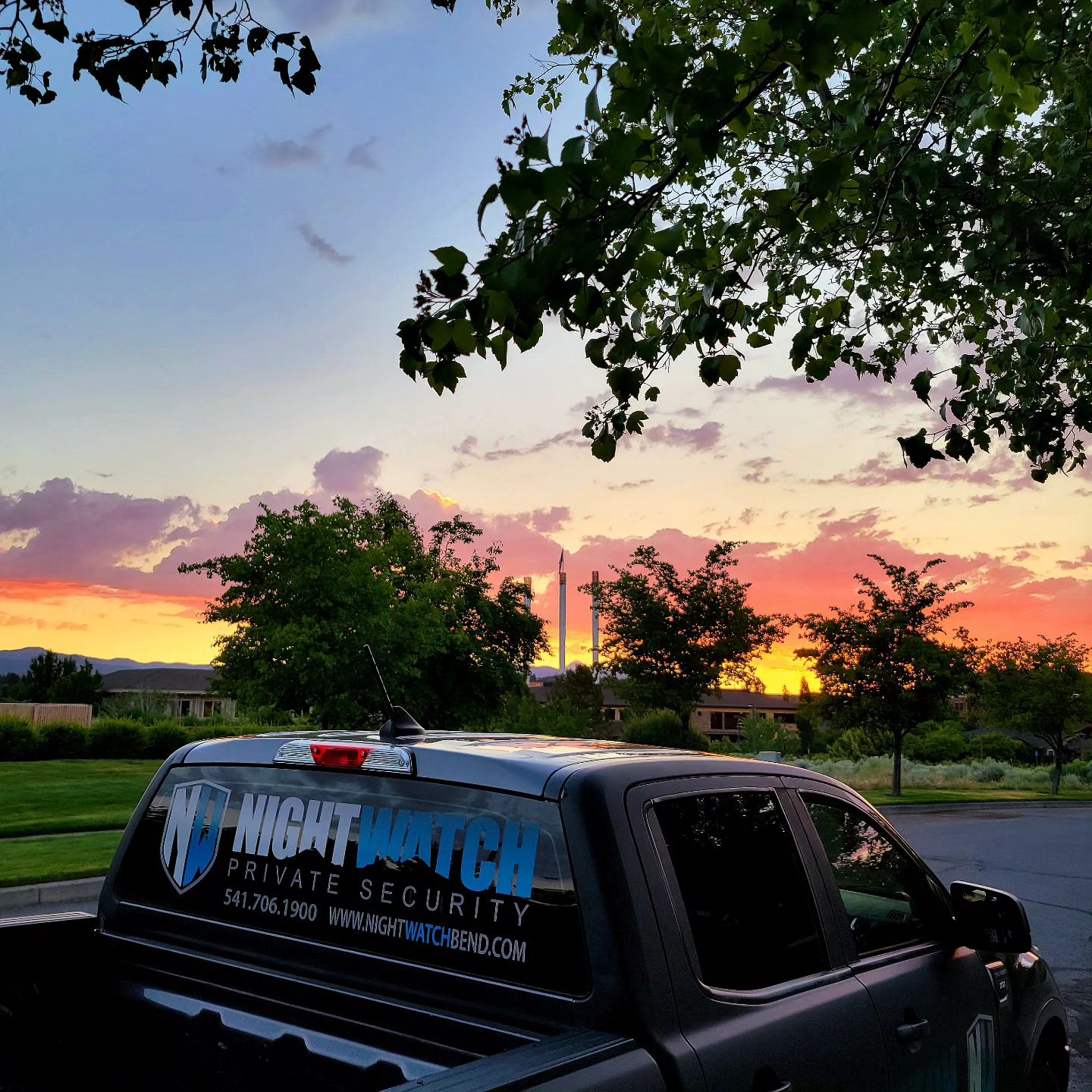 A parked truck with a sunset in the background.