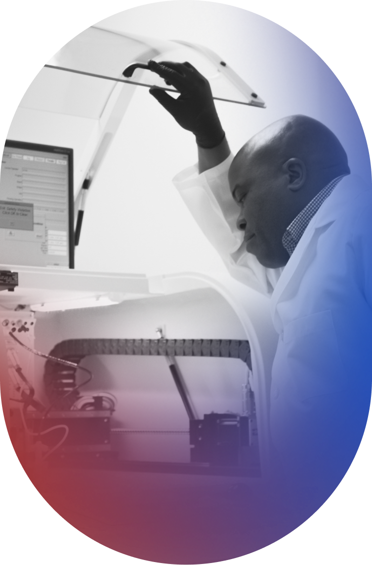 A male team member opening a machine while manufacturing the Paradromics Brain-Computer Interface Cortical Module