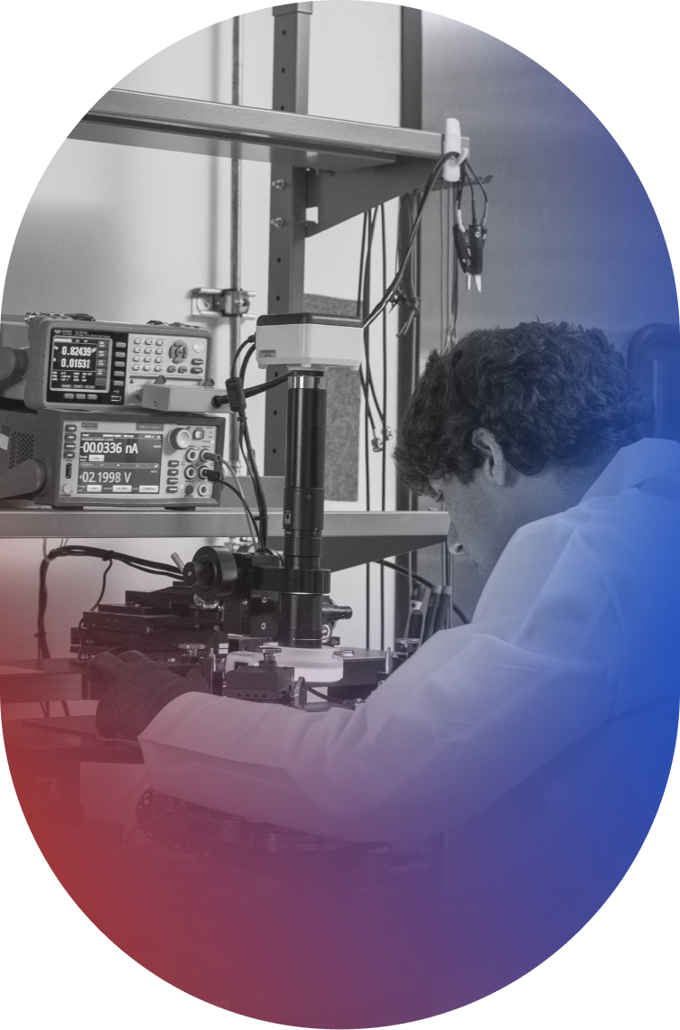 A male engineer working on a machine during the process of testing a Paradromics Brain-Computer Interface Cortical Module