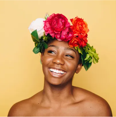 woman with flowers on her head smiling  - volunteer - best organization website webflow CMS template