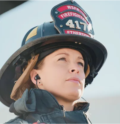 a young girl wearing a fireman's helmet and ear phones - volunteer - best organization website webflow CMS template