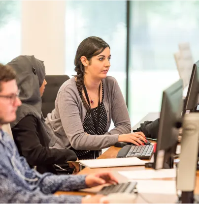 a group of people sitting at a table working on computers - volunteer - best organization website webflow CMS template