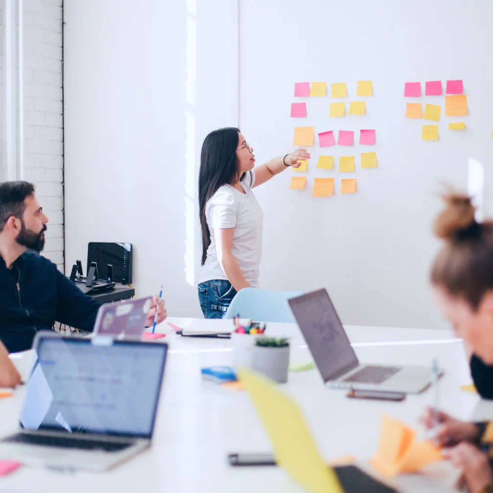a group of people sitting around a table with laptops - volunteer - best organization website webflow CMS template