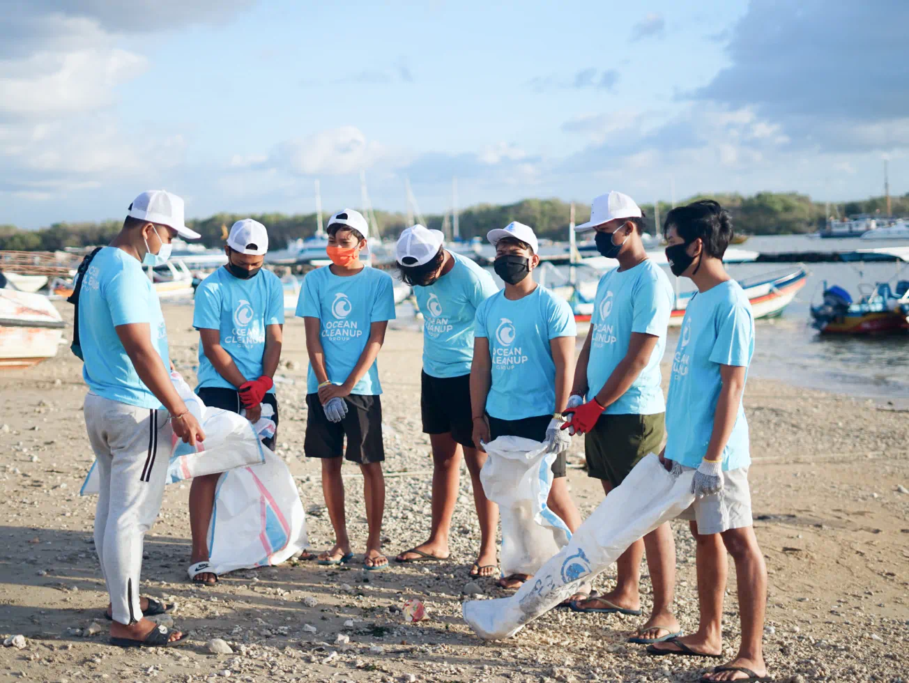 a group of people standing on top of a sandy beach - volunteer - best organization website webflow CMS template