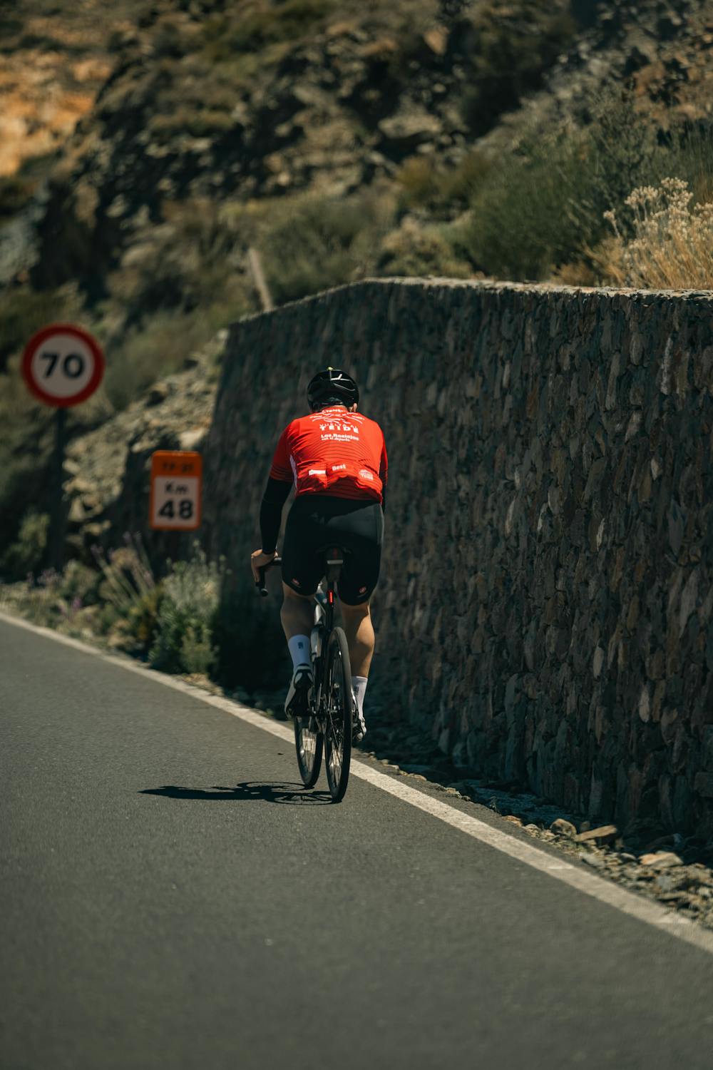 Cyclist riding uphill during a high-intensity VO2 max interval training session