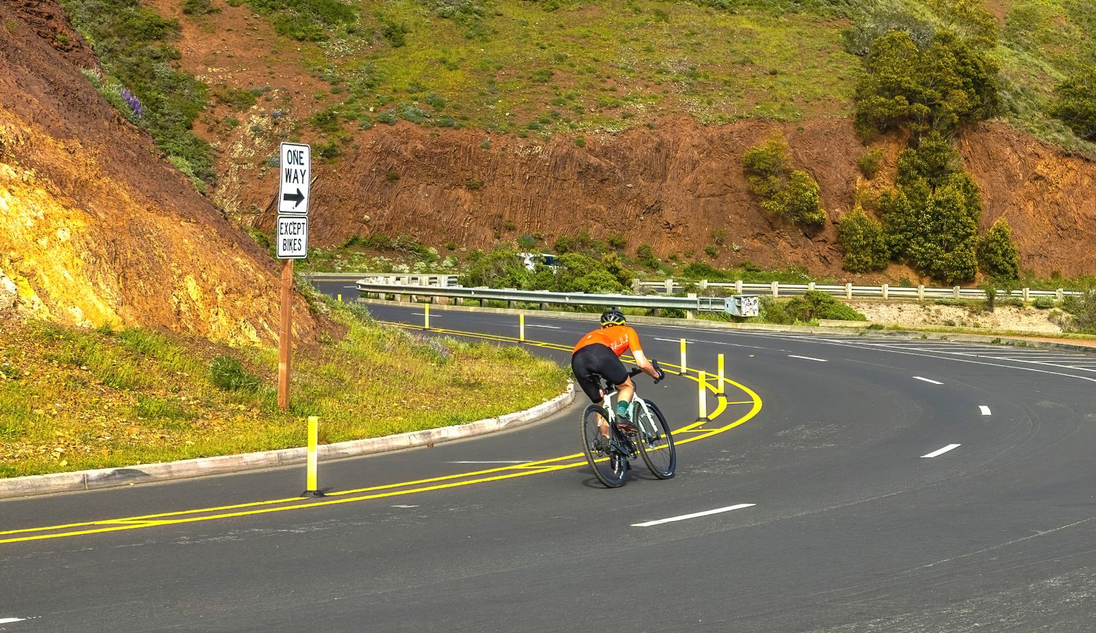 Cyclist on a scenic mountain road representing endurance and aerobic capacity training