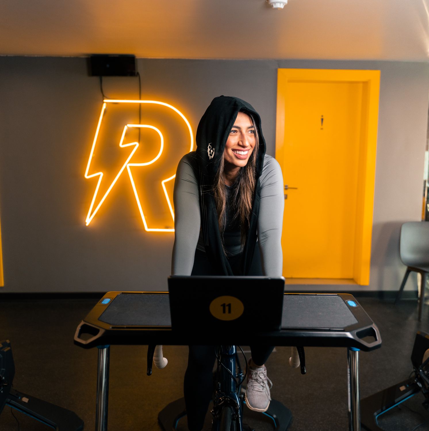 Indoor cyclist riding in a virtual cycling app environment