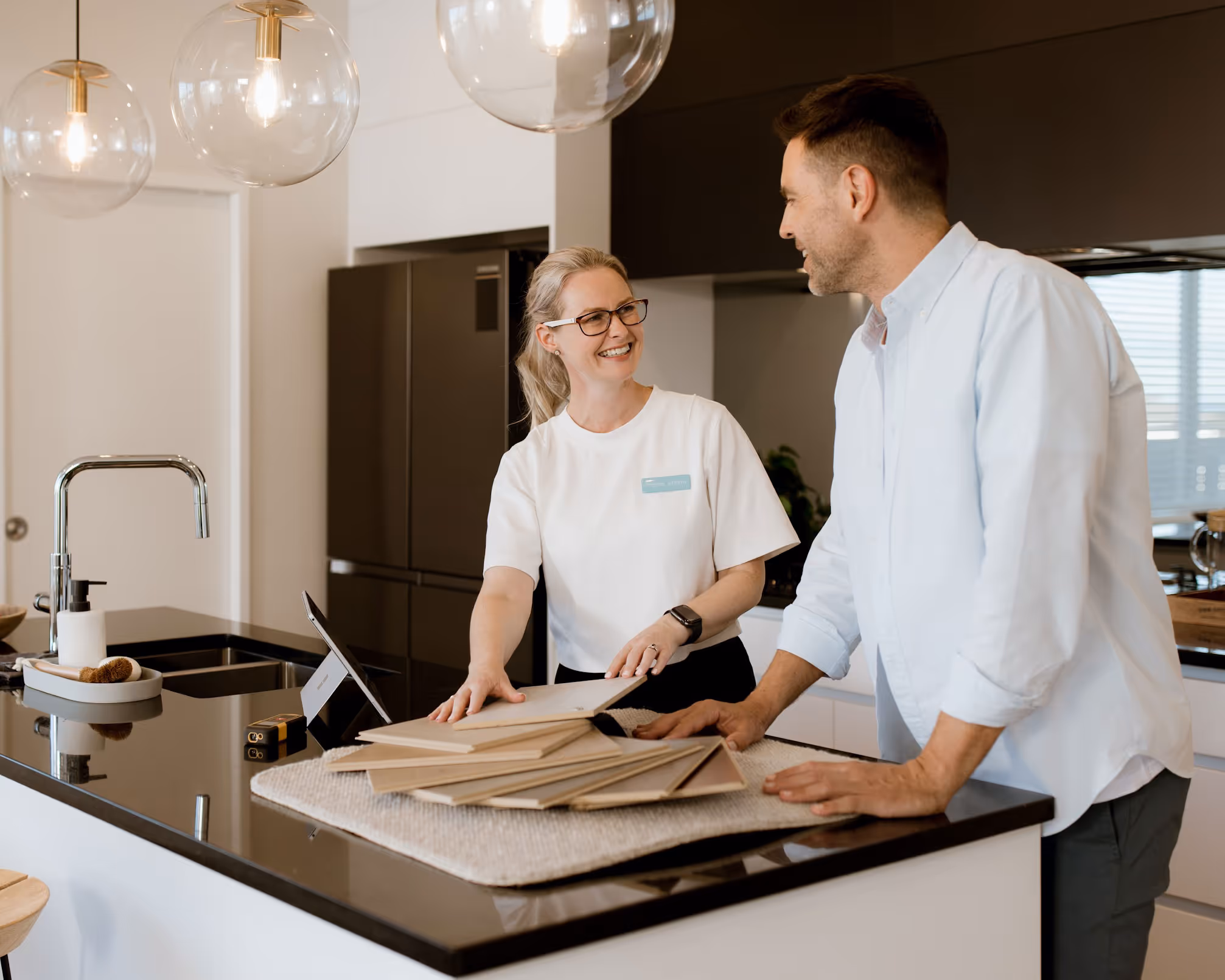 a man and woman standing in a kitchen
