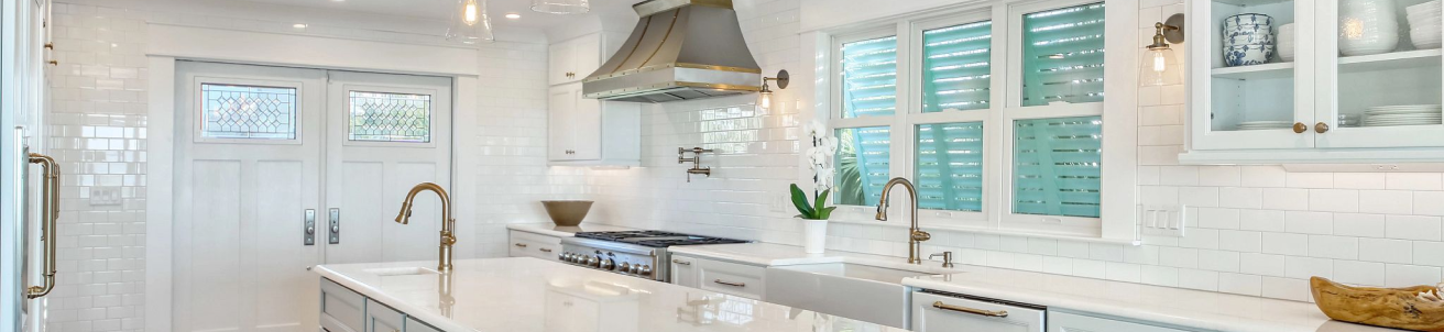 A kitchen with a sink and a stove top oven