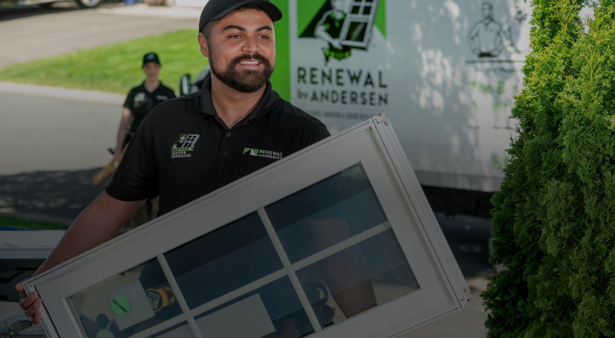 A man holding a framed picture in front of a truck