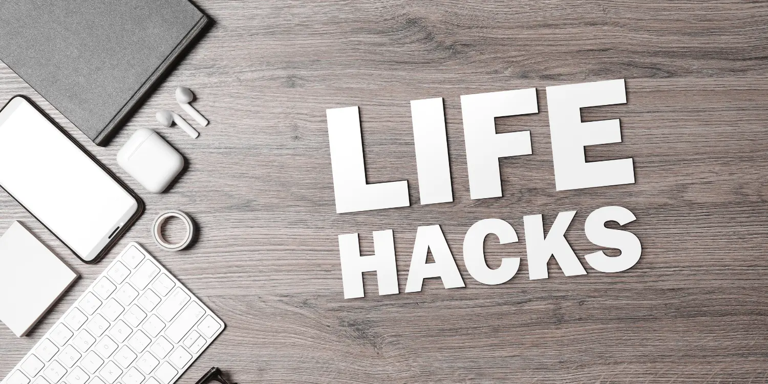 The words "life hacks" spelled out on a desk next a cell phone, keyboard, and other electronics concerning life hacks for credit.