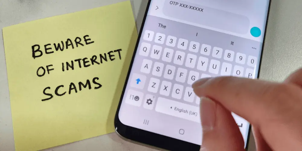 A person on their phone learning about protection from loan scams via Credit.org financial blogs