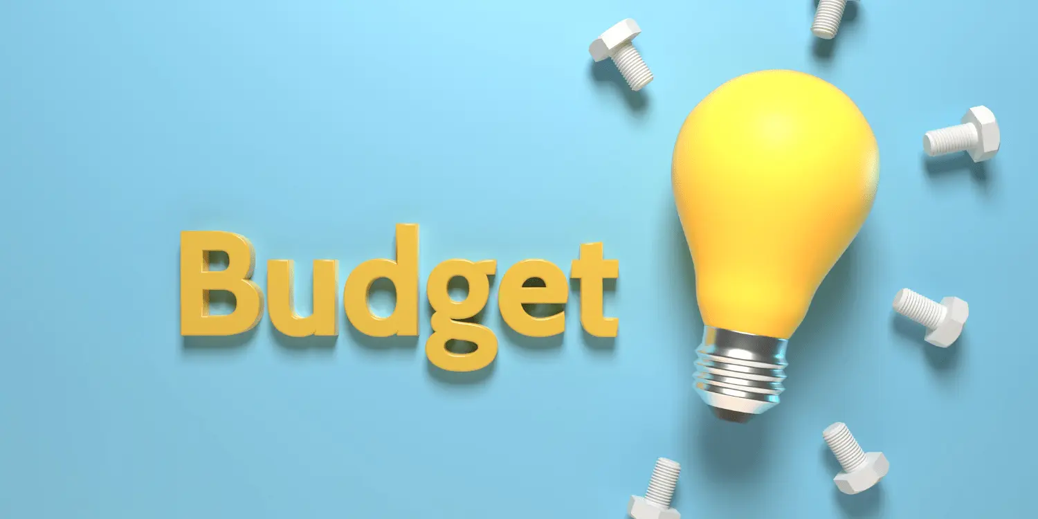 A light bulb shining with the budget next to it showing budgeting as a good idea.