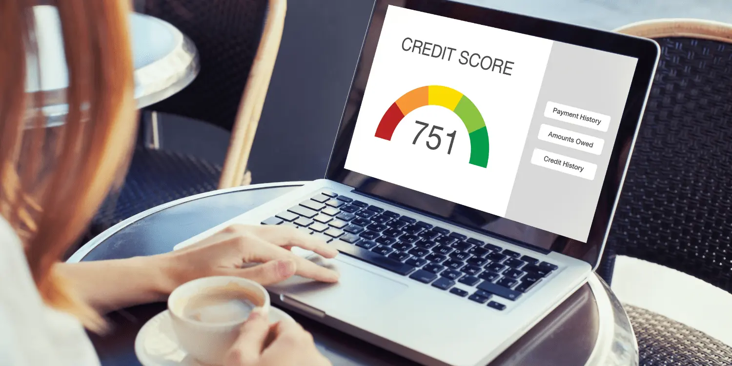 A person at a laptop finding out how credit monitoring can help you keep track of your credit score for better financial planning.