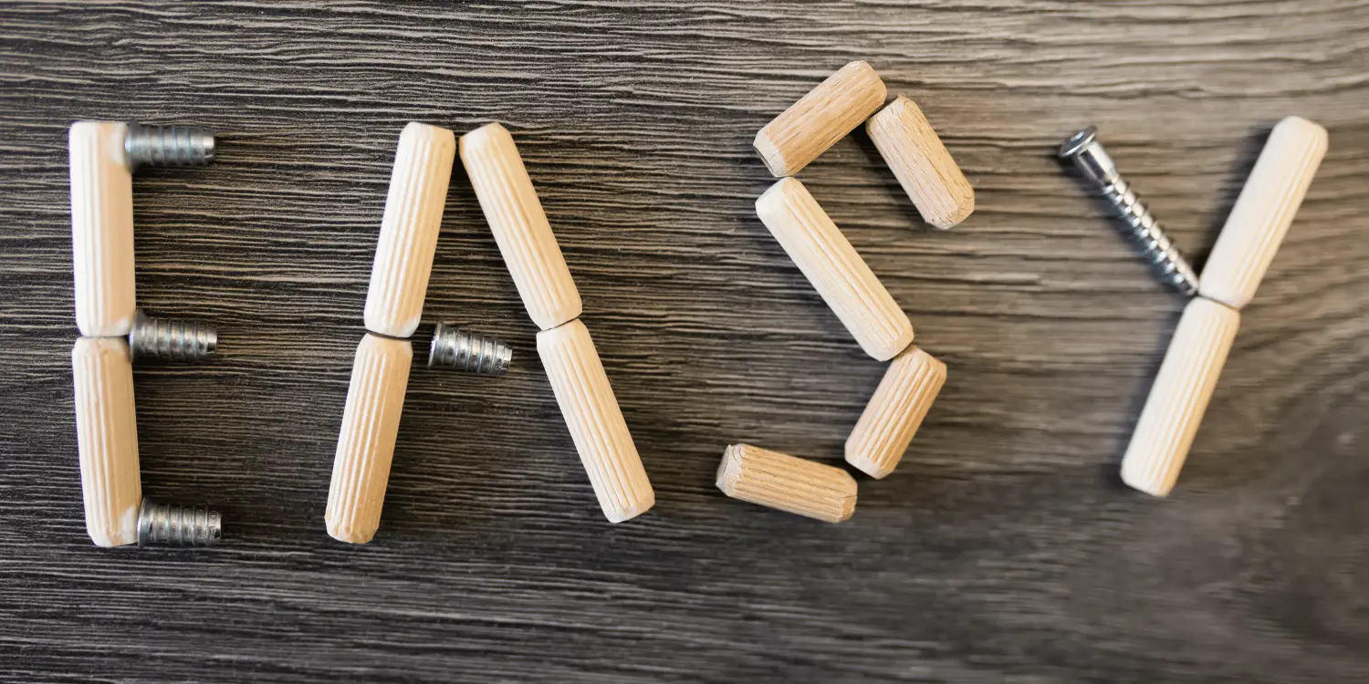 Many small tubes put together to spell out "easy" on top of a table.