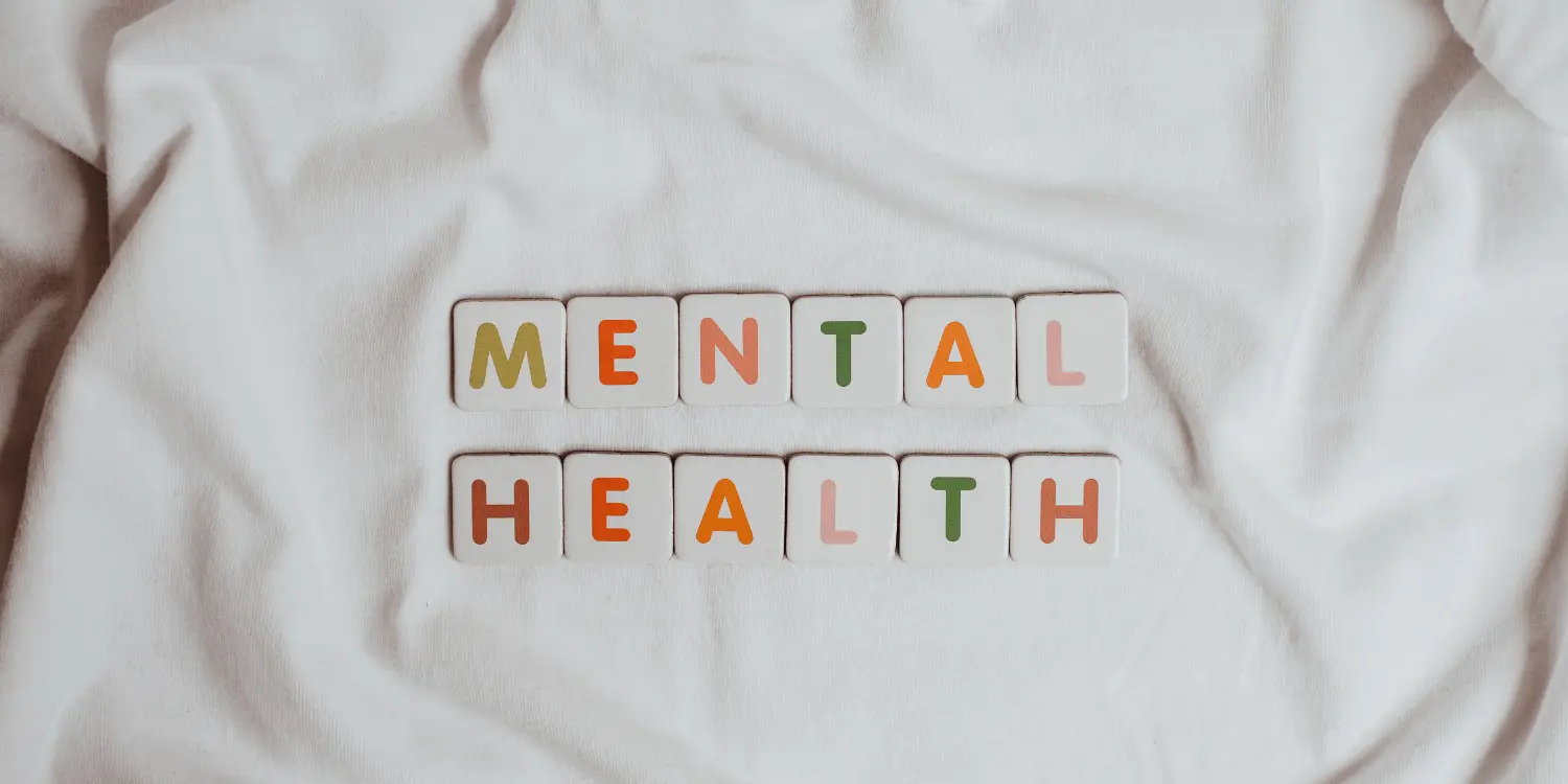 The words "mental health" spelled in scrabble tiles for the holidays.
