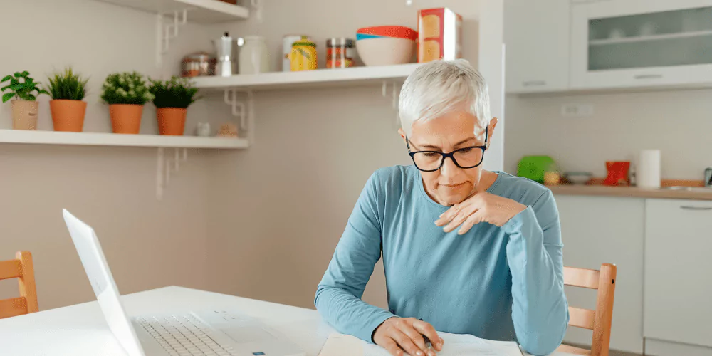 senior woman looking over her reverse mortgage documentation to see if it is the best option for retirement.