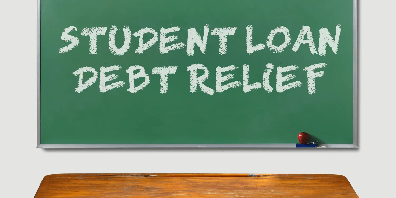 A blackboard with the words student loan debt relief written on it encouraging relief from student loan debt.