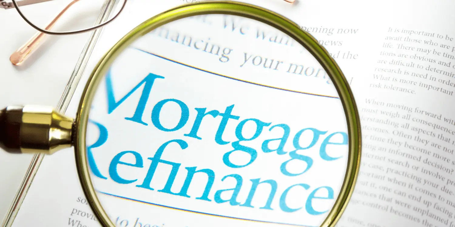 A paper with a magnify glass that is hovering over the words 'mortgage refinance".