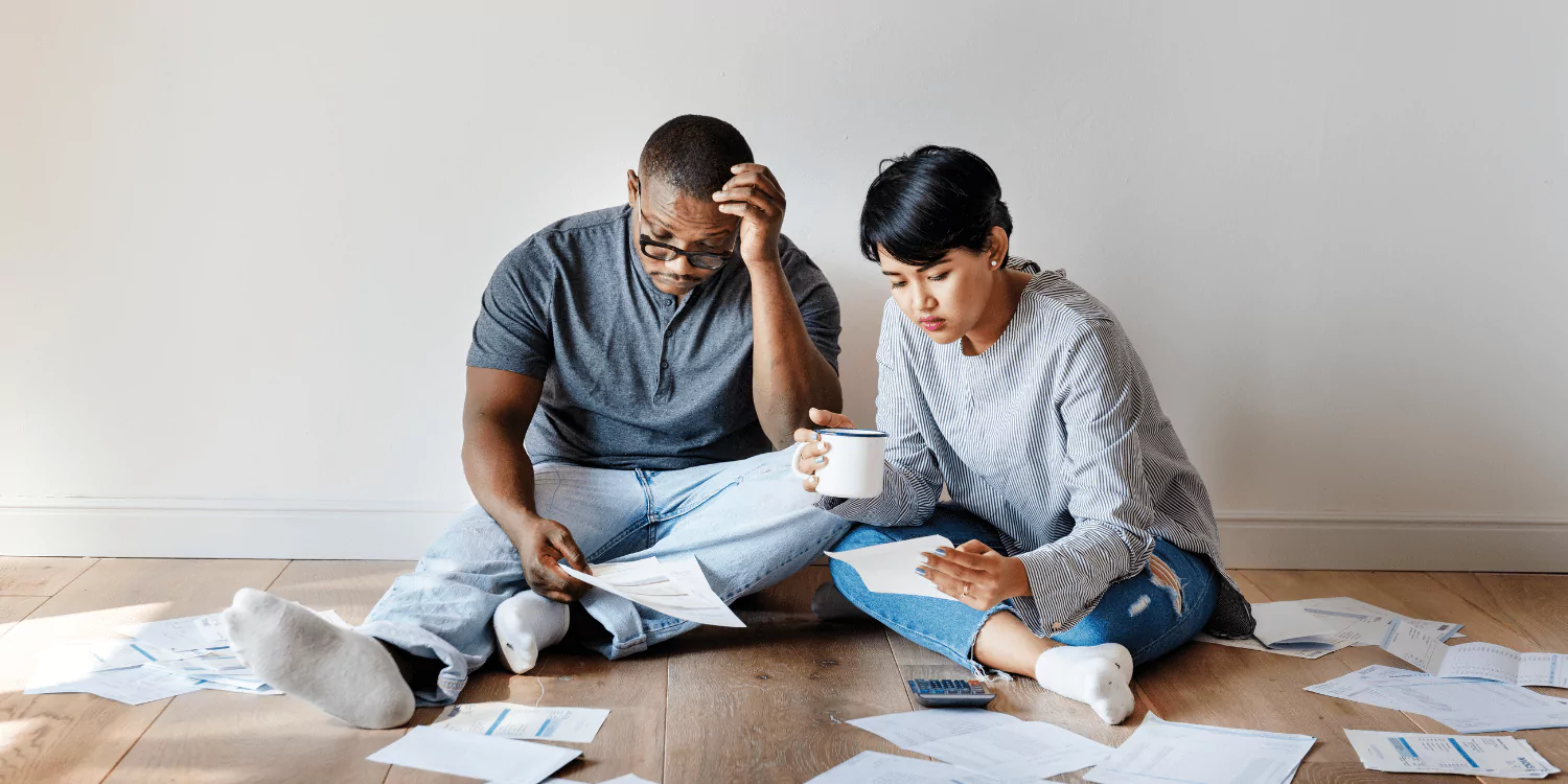 A couple that is looking over their debt to see if a debt management plan is the best debt relief option for them.
