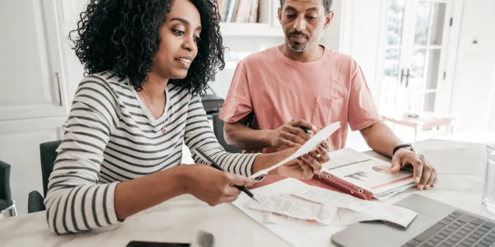 Black American couple preparing for the mortgage lending process for a home mortgage to ensure they get great payment options and a lower interest rate.