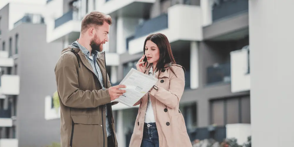 Couple reviewing apartment listings while budgeting for affordable rent options in the city.