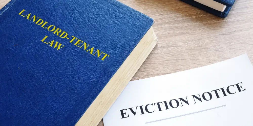 Legal book on landlord-tenant law with eviction notice, reminding renters to know their rights and options.