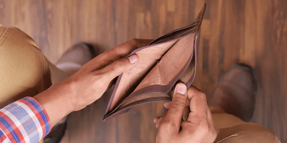Empty wallet in hands, symbolizing financial hardship and support available for renters who lost income unexpectedly.
