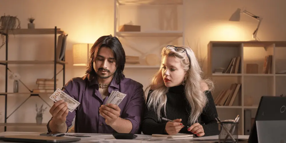 Couple counting cash together, symbolizing renters in crisis using a free budget template to stay on track.