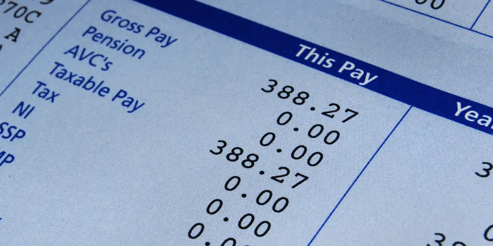 Pay stub with small income amount—complete budget guide for renting on minimum wage.