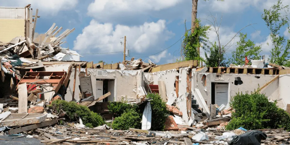 Storm-damaged home reduced to rubble, showing why FEMA disaster assistance is vital for families after emergencies.