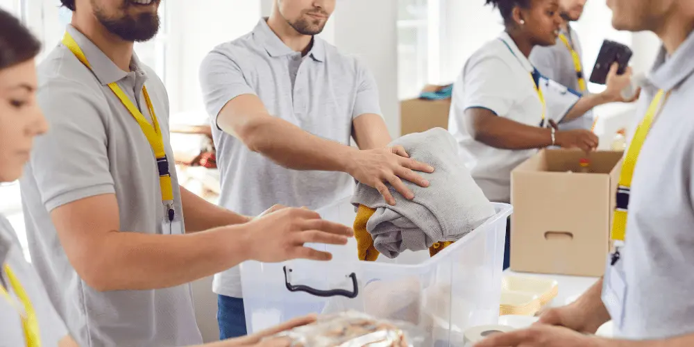 Volunteers organize clothing and supplies for families recovering from disaster with support from FEMA relief programs.