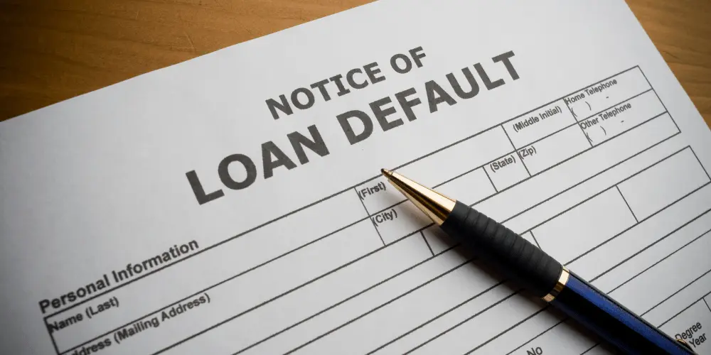 Notice of loan default document with pen highlights risks of reverse mortgage default and the importance of prevention.