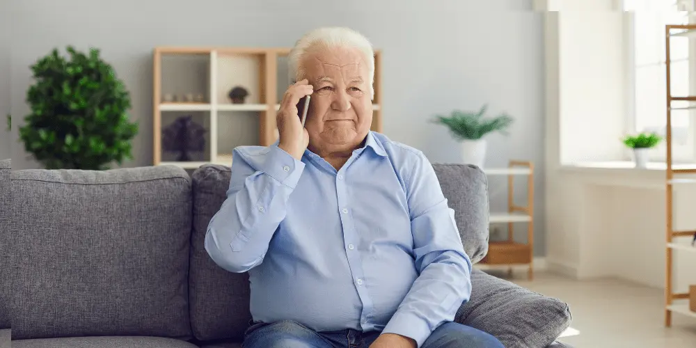 Senior homeowner worried about reverse mortgage payments, considering default counseling for guidance and support.