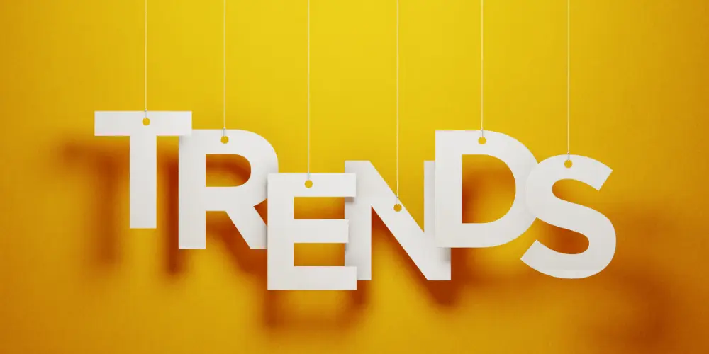 White letters spelling “Trends” on a bright yellow background, representing reverse mortgage default rate patterns.