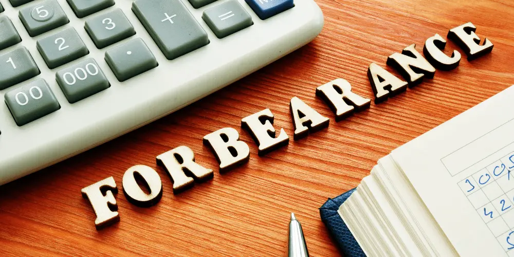 Word “Forbearance” beside calculator showing mortgage payment relief options after a disaster.