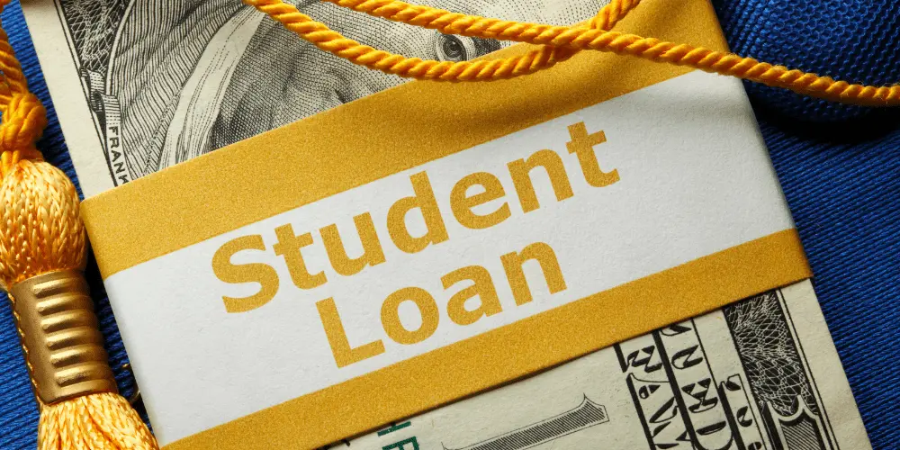 Graduation tassel and cash labeled ‘Student Loan,’ highlighting the financial pressure when borrowers can’t afford payments.