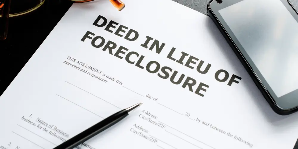 Deed in lieu of foreclosure agreement form on a desk, showing the paperwork homeowners complete to avoid foreclosure.