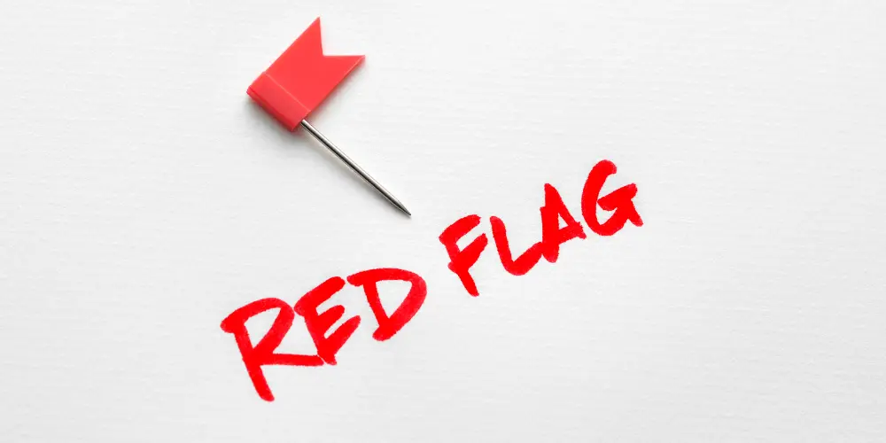 Red flag symbol representing warning signs homebuyers should watch for during a home inspection before negotiating repairs.