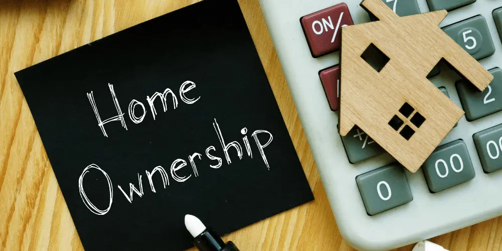 Homeownership concept with calculator and house icon, symbolizing budgeting and financial planning in your first year as a homeowner.