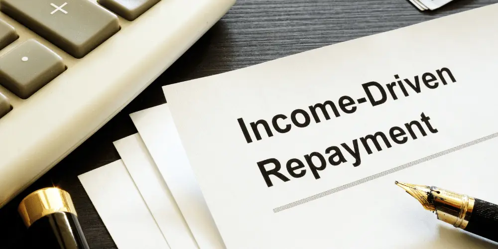 Income-driven repayment plans overview showing documents and pen, highlighting student loan payment options based on income.