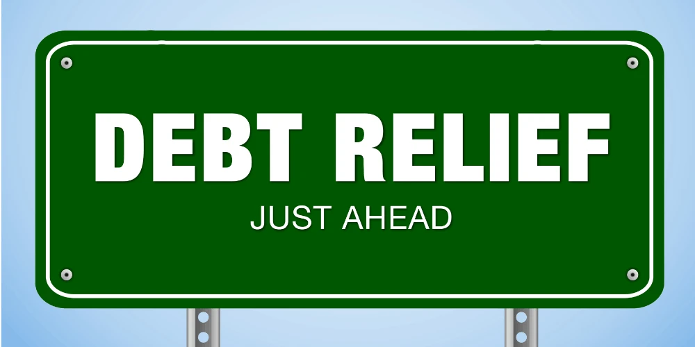 Road sign reading “Debt Relief Just Ahead,” symbolizing hope and clarity about how debt relief works and what to expect.